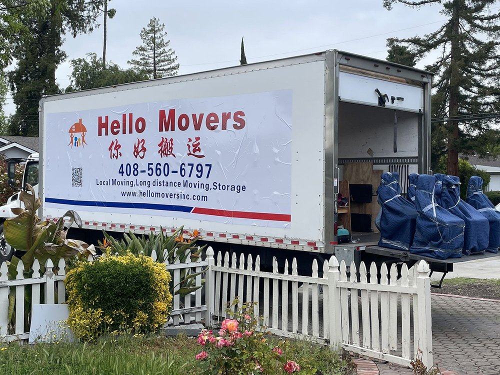 A Hello Movers truck with wrapped furniture at a Bay Area home